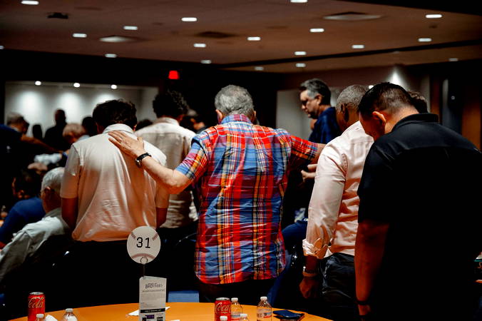 Men standing in prayer