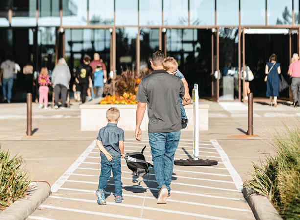 Man walking his kids into church